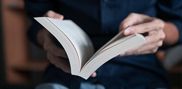 Person flipping through the pages of a book.